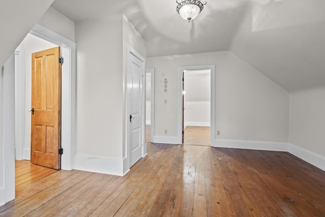 bonus room featuring lofted ceiling and light hardwood / wood-style flooring