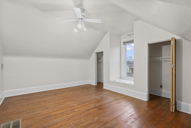 additional living space featuring wood-type flooring, lofted ceiling, and ceiling fan