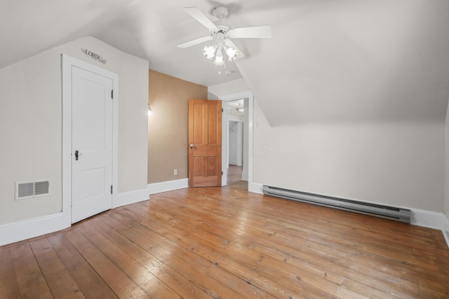 additional living space featuring lofted ceiling, a baseboard heating unit, light hardwood / wood-style floors, and ceiling fan