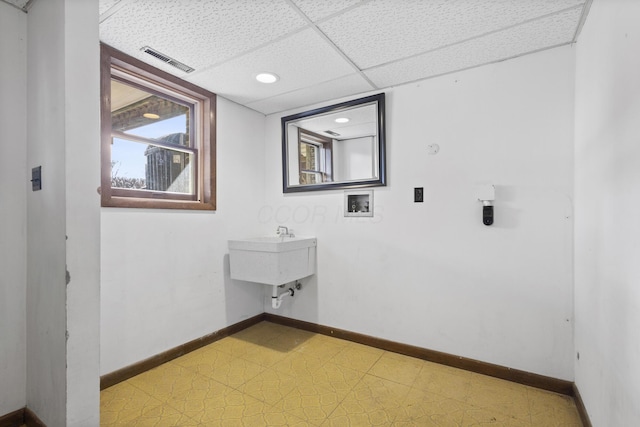 clothes washing area featuring hookup for a washing machine and sink