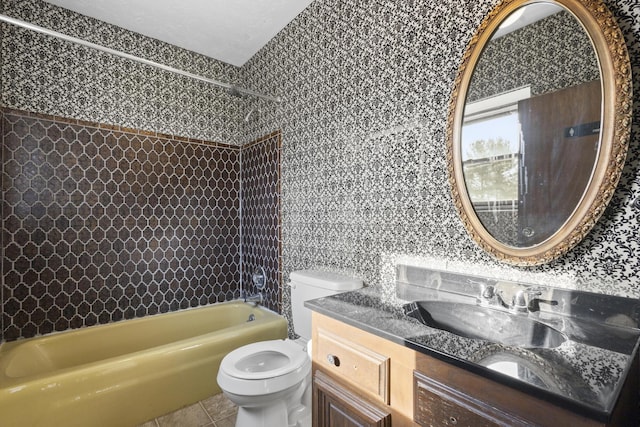 full bathroom featuring tile walls, vanity, tile patterned floors, toilet, and tiled shower / bath