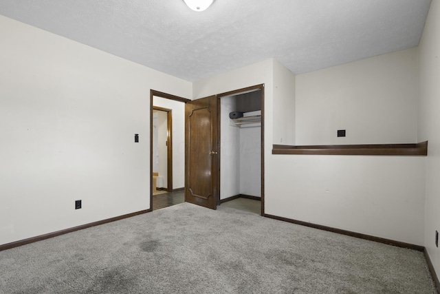 unfurnished bedroom with light colored carpet, a textured ceiling, and a closet