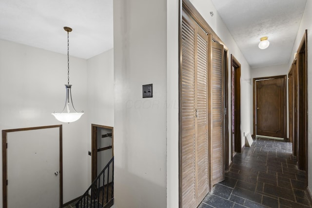 hallway with a textured ceiling