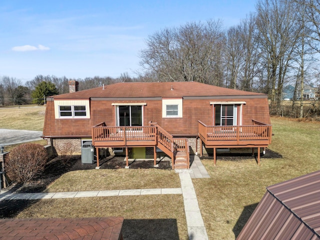 rear view of house with a yard, cooling unit, and a deck