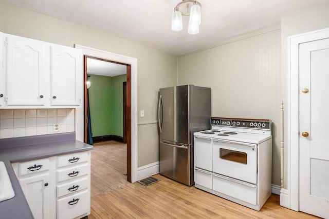 kitchen featuring stainless steel refrigerator, tasteful backsplash, white cabinets, double oven range, and light hardwood / wood-style floors