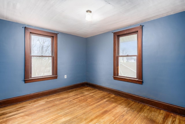 spare room with light hardwood / wood-style floors and a wealth of natural light