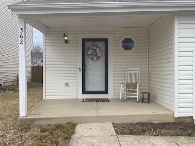 view of exterior entry with covered porch