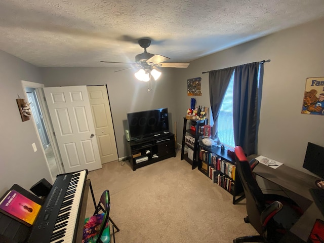 home office with ceiling fan, light carpet, and a textured ceiling