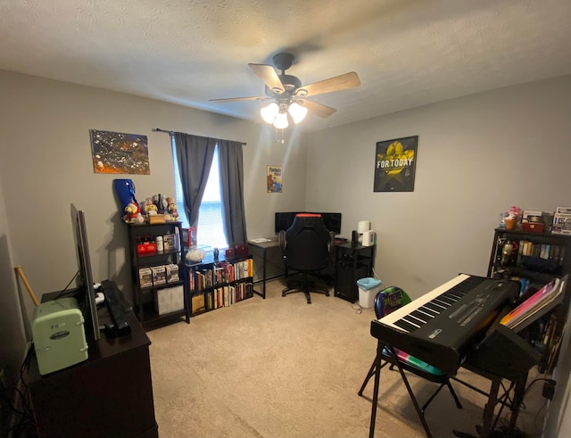 carpeted office with ceiling fan and a textured ceiling