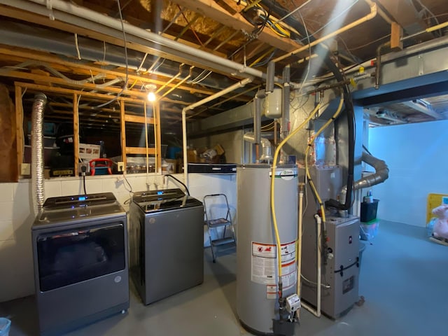 basement with washer and clothes dryer and water heater