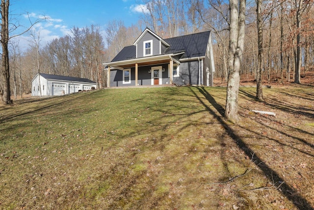 view of front of home featuring a garage, a front yard, and covered porch