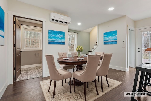 dining space featuring dark wood-type flooring and a wall unit AC