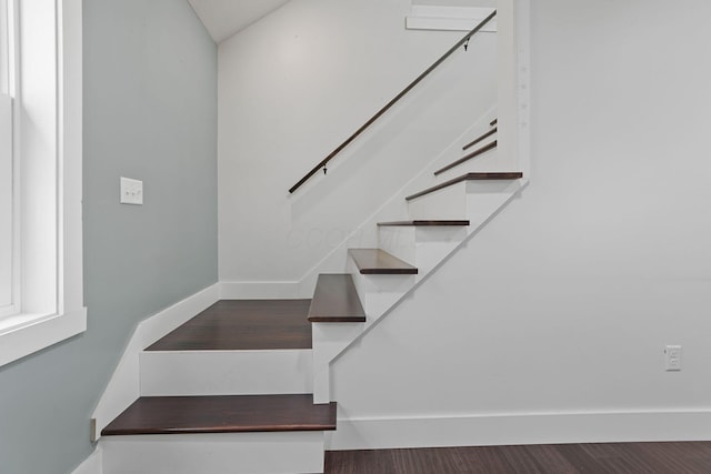 stairway with hardwood / wood-style flooring