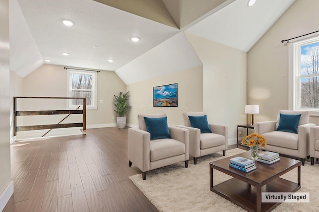 living room with vaulted ceiling and light wood-type flooring