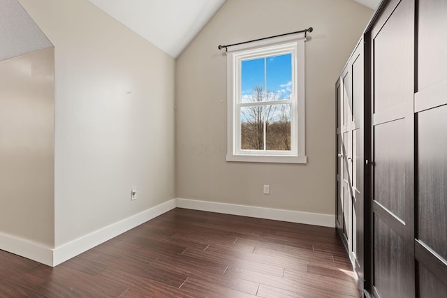 interior space featuring dark hardwood / wood-style floors and vaulted ceiling