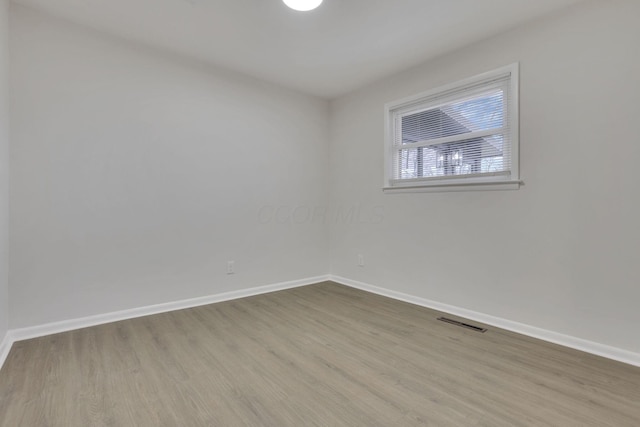 unfurnished room with light wood-type flooring