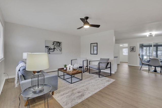 living room featuring ceiling fan and light hardwood / wood-style flooring