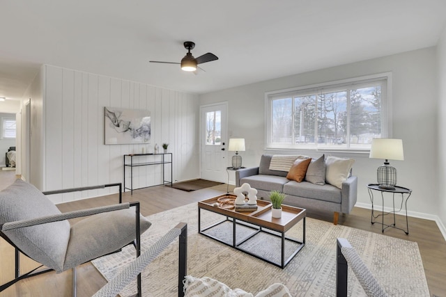 living room with ceiling fan and light hardwood / wood-style flooring