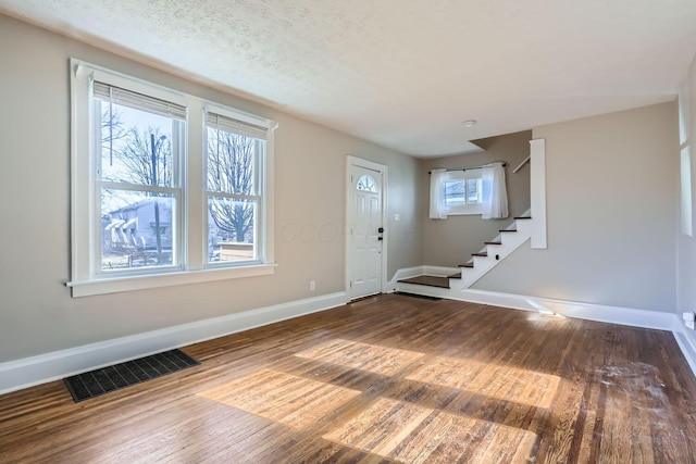 entryway featuring a textured ceiling and hardwood / wood-style floors