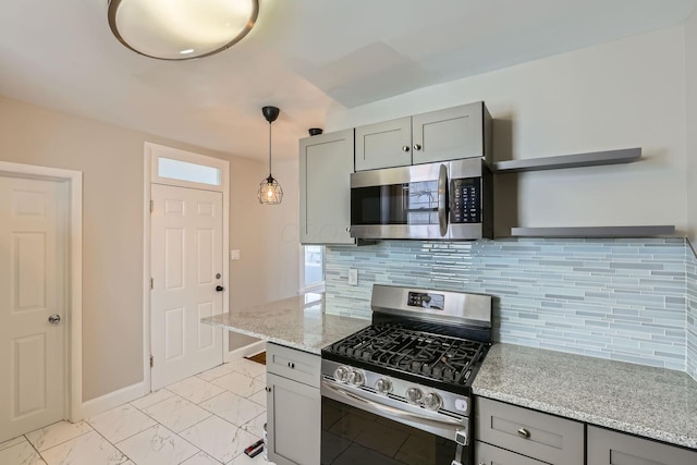 kitchen with gray cabinetry, light stone countertops, backsplash, appliances with stainless steel finishes, and pendant lighting