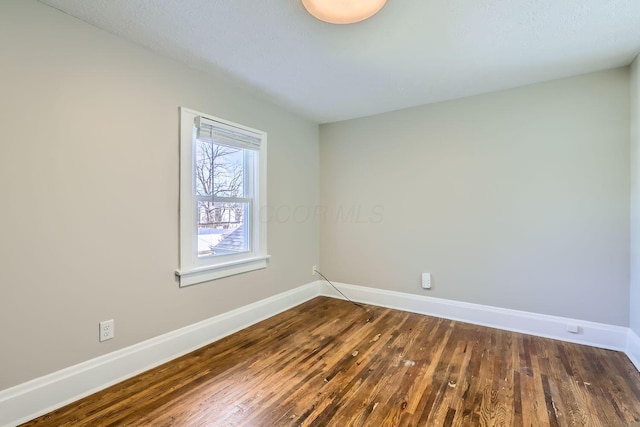 unfurnished room with dark hardwood / wood-style floors