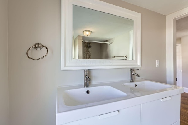 bathroom featuring hardwood / wood-style flooring and vanity