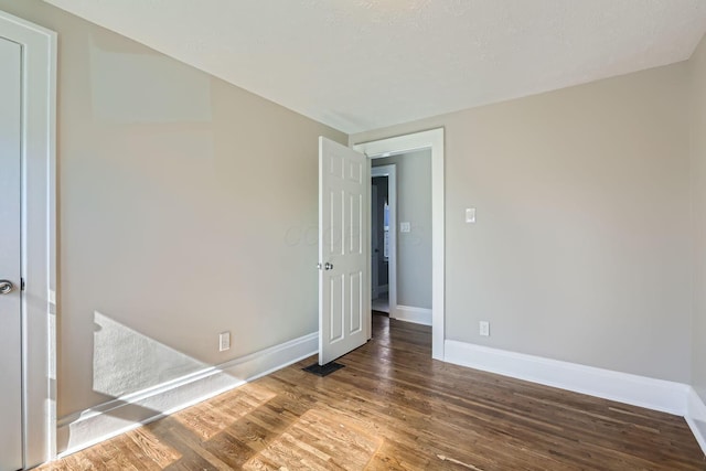 spare room featuring dark hardwood / wood-style flooring