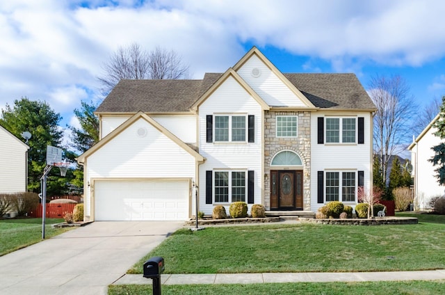 colonial home featuring a garage and a front lawn