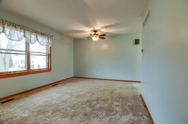 carpeted spare room with ceiling fan