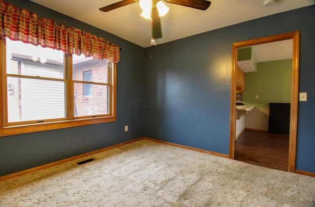 empty room with carpet flooring and ceiling fan