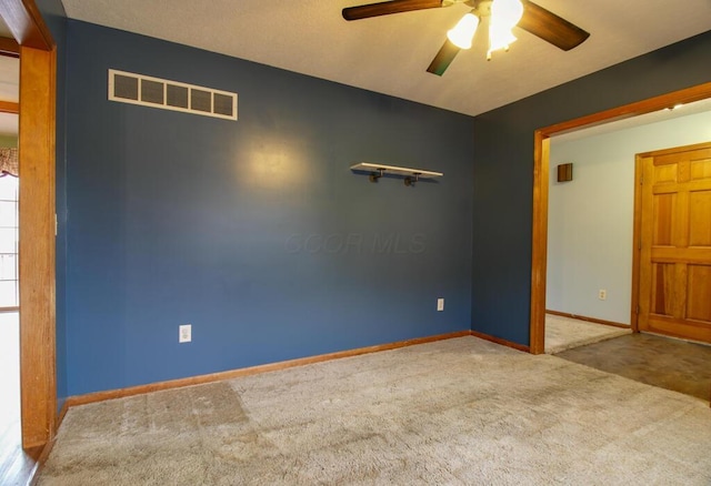 spare room with ceiling fan and carpet flooring