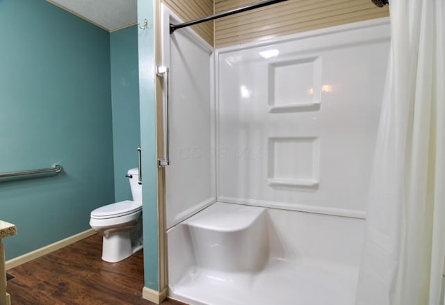 bathroom featuring vanity, toilet, hardwood / wood-style floors, and a shower