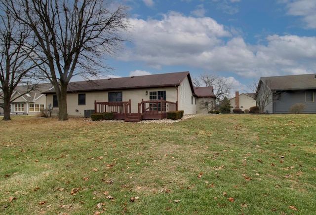 back of house with a wooden deck, a lawn, and central air condition unit