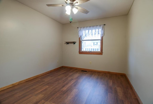 spare room featuring dark hardwood / wood-style floors and ceiling fan