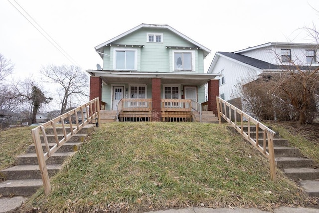 view of front facade with covered porch and a front lawn