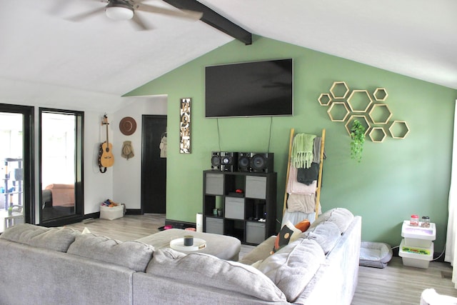 living room featuring light hardwood / wood-style flooring, lofted ceiling with beams, and ceiling fan