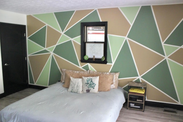 bedroom with wood-type flooring