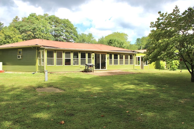 back of property featuring cooling unit, a patio, and a lawn