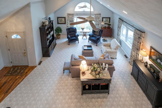 living room featuring ceiling fan, light hardwood / wood-style floors, and high vaulted ceiling