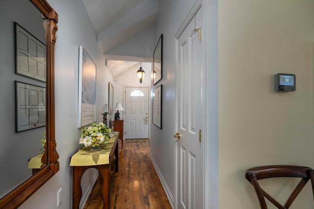 hallway featuring vaulted ceiling and dark hardwood / wood-style flooring