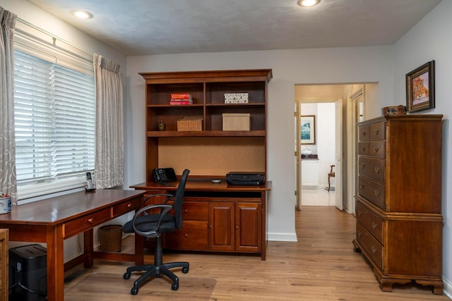 office area with light hardwood / wood-style floors