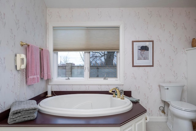 bathroom featuring a bath and toilet