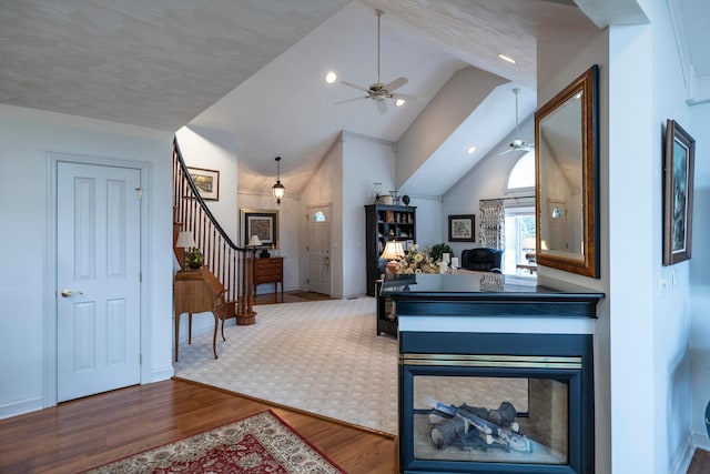 interior space featuring hardwood / wood-style flooring, lofted ceiling, and ceiling fan