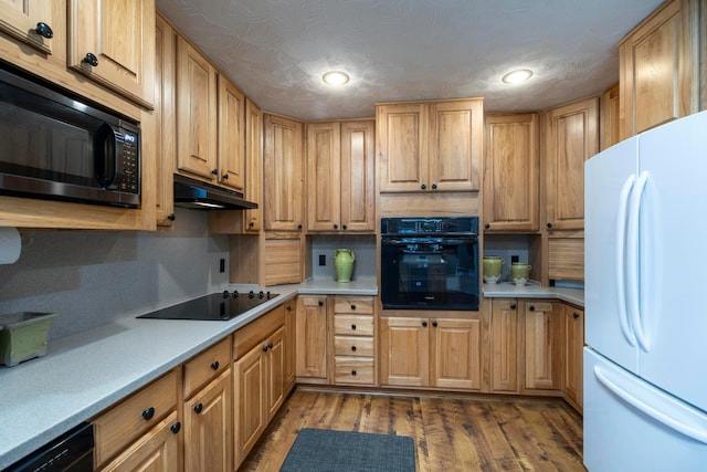 kitchen with hardwood / wood-style flooring and black appliances