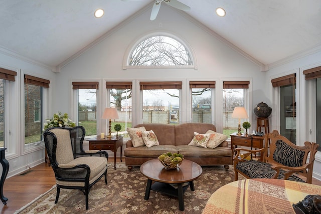 sunroom / solarium featuring vaulted ceiling, a healthy amount of sunlight, and ceiling fan