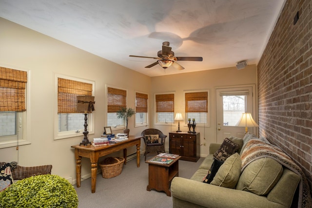 carpeted office with brick wall and ceiling fan