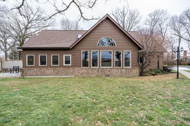 rear view of property featuring a yard and a patio area