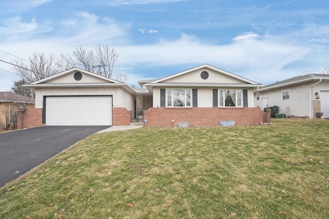 ranch-style home with aphalt driveway, an attached garage, brick siding, stucco siding, and a front lawn