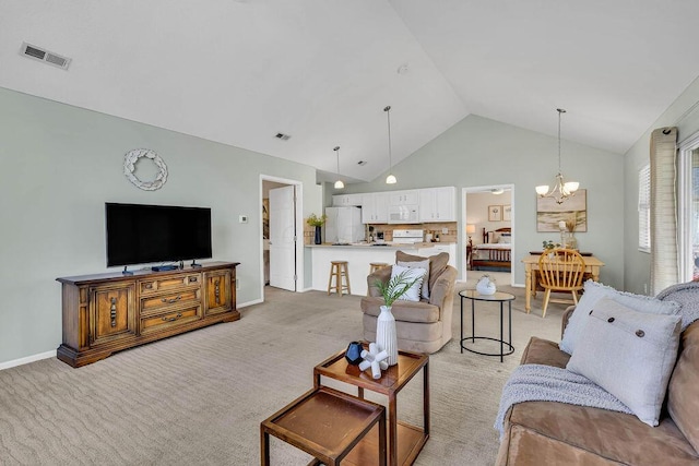 living area featuring baseboards, visible vents, high vaulted ceiling, light carpet, and a chandelier