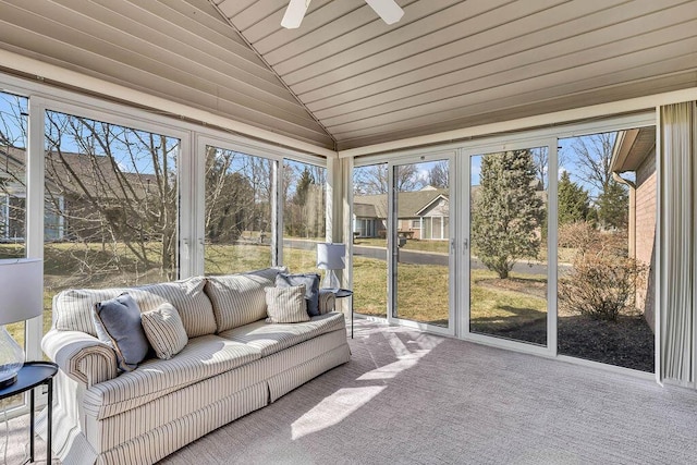 unfurnished sunroom with lofted ceiling and ceiling fan